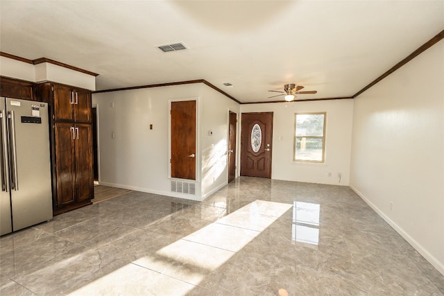 tiled entryway with ceiling fan and ornamental molding