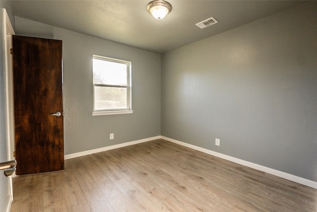 unfurnished room with hardwood / wood-style flooring