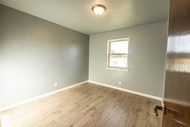 unfurnished room with wood-type flooring