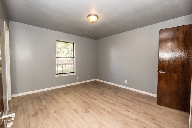 spare room featuring light hardwood / wood-style flooring