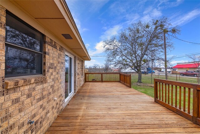 wooden deck with a lawn