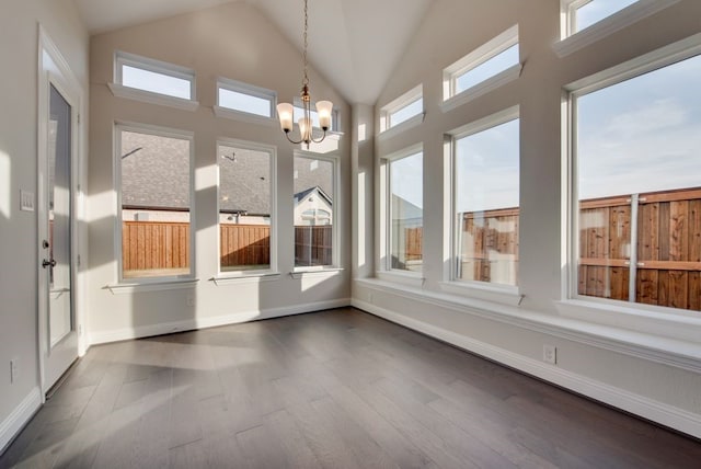 unfurnished sunroom featuring a chandelier and lofted ceiling