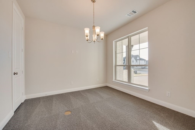 carpeted spare room featuring a chandelier and a healthy amount of sunlight