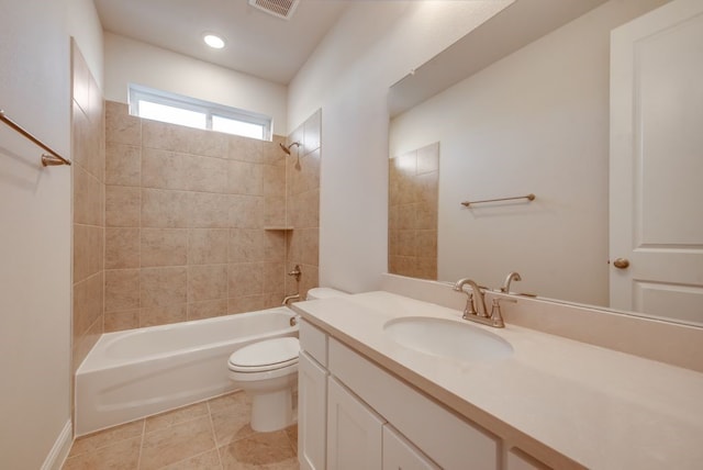 full bathroom featuring toilet, vanity, tile patterned floors, and tiled shower / bath