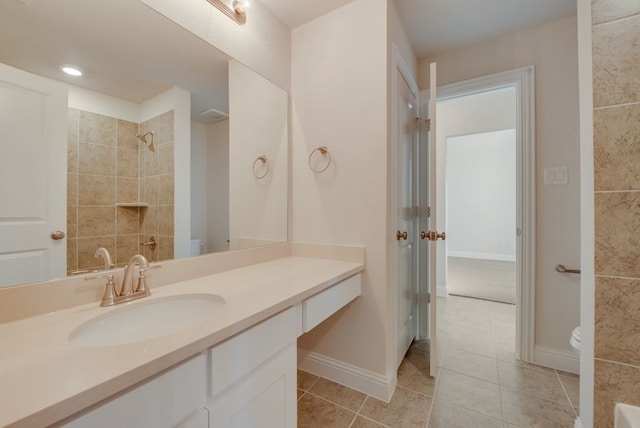 bathroom with tile patterned flooring, vanity, and toilet