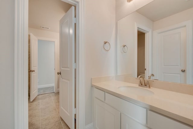 bathroom featuring tile patterned flooring and vanity