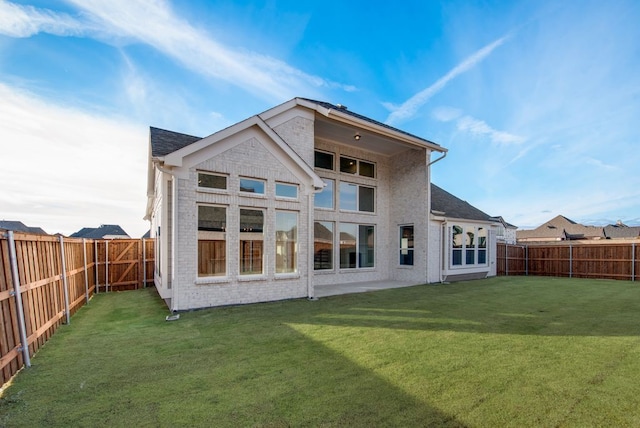 back of house featuring a yard