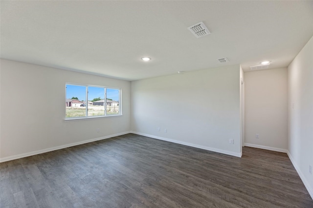 spare room featuring dark hardwood / wood-style flooring