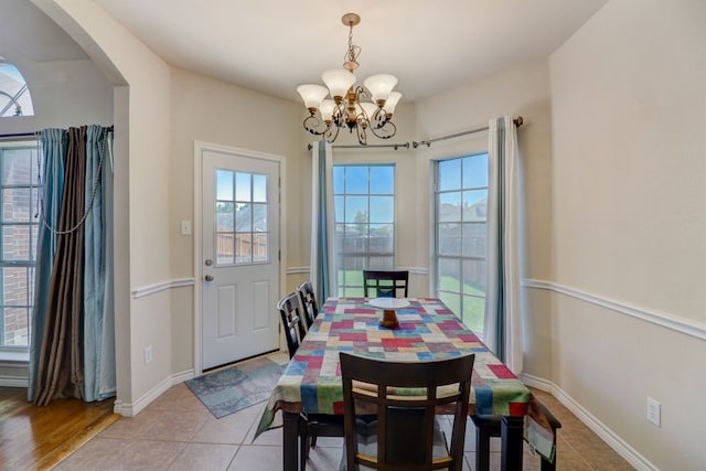 tiled dining area featuring a notable chandelier