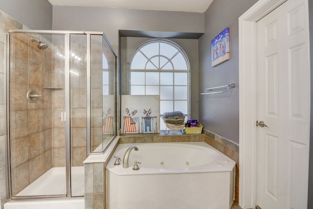 bathroom featuring separate shower and tub