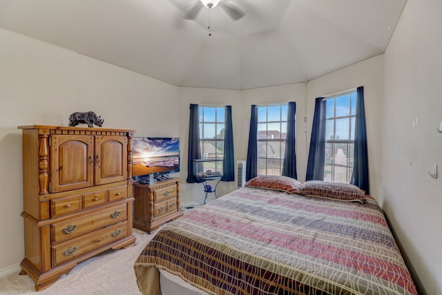 carpeted bedroom featuring vaulted ceiling, ceiling fan, and multiple windows