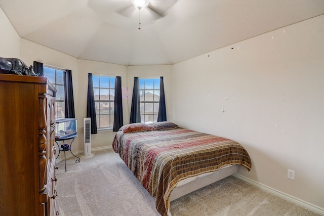 bedroom featuring lofted ceiling, multiple windows, carpet flooring, and ceiling fan