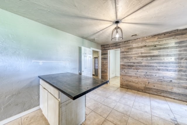 kitchen featuring white cabinetry and light tile patterned floors