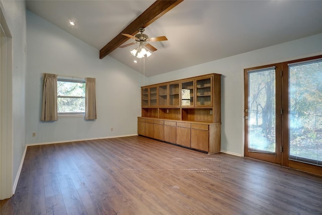 unfurnished living room featuring vaulted ceiling with beams, ceiling fan, and wood-type flooring