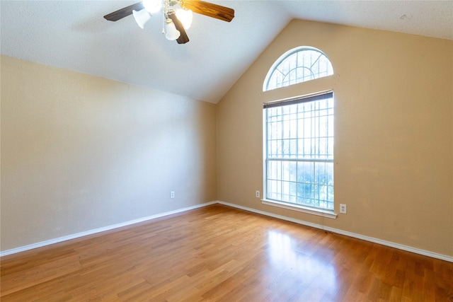 unfurnished room featuring lofted ceiling, ceiling fan, light wood-type flooring, and a textured ceiling