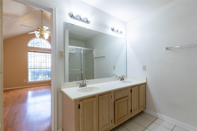 bathroom with lofted ceiling, hardwood / wood-style flooring, ceiling fan, a textured ceiling, and an enclosed shower