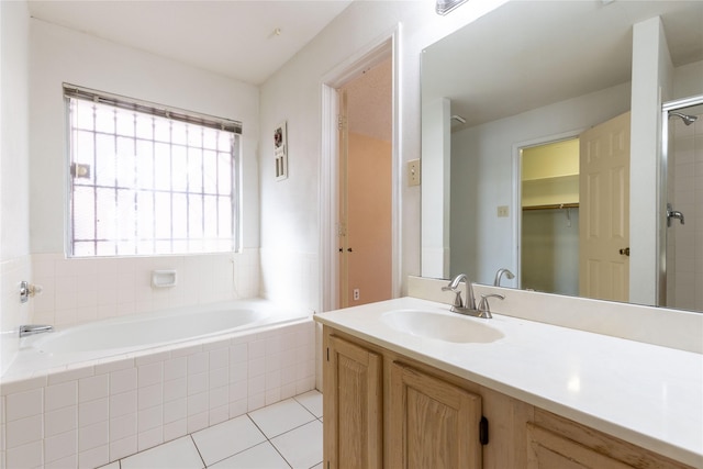 bathroom with tile patterned floors, separate shower and tub, and vanity