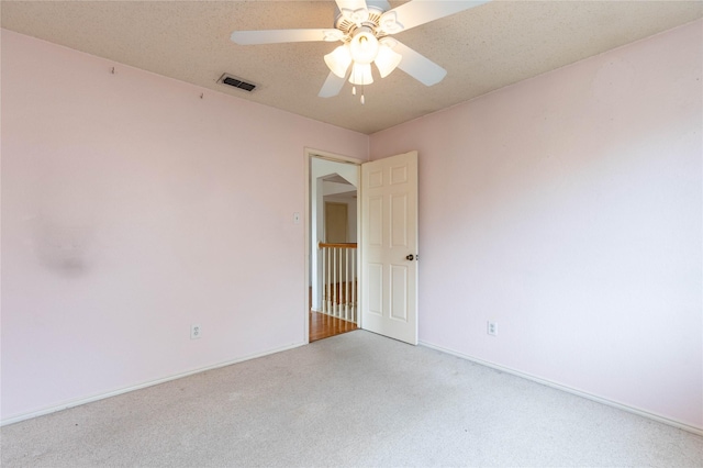 unfurnished room featuring ceiling fan and a textured ceiling