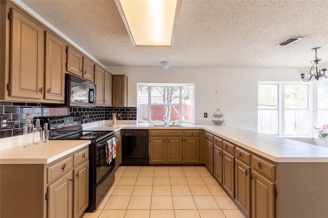 kitchen with an inviting chandelier, black appliances, sink, light tile patterned flooring, and kitchen peninsula