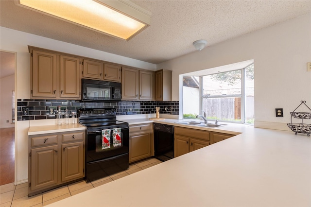 kitchen featuring backsplash, black appliances, sink, a textured ceiling, and light tile patterned flooring