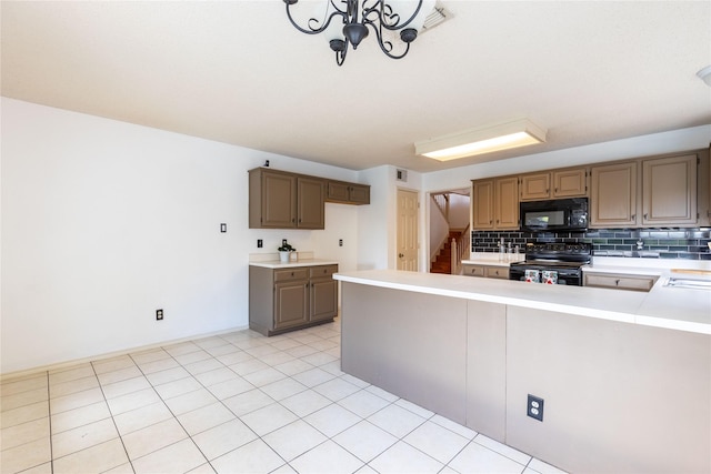 kitchen with a chandelier, decorative backsplash, light tile patterned floors, and black appliances