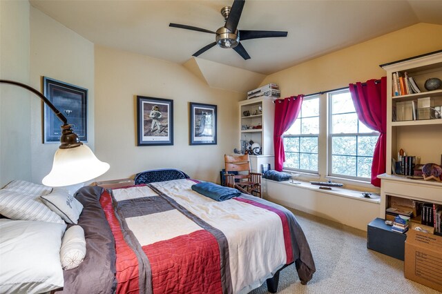 carpeted bedroom featuring ceiling fan and vaulted ceiling