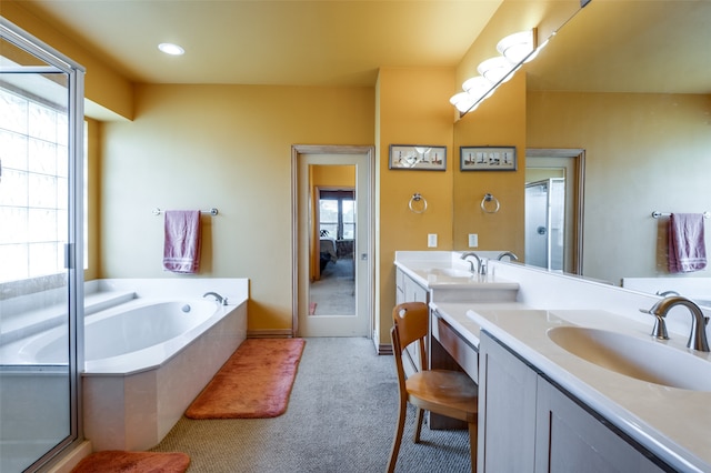 bathroom featuring vanity and separate shower and tub