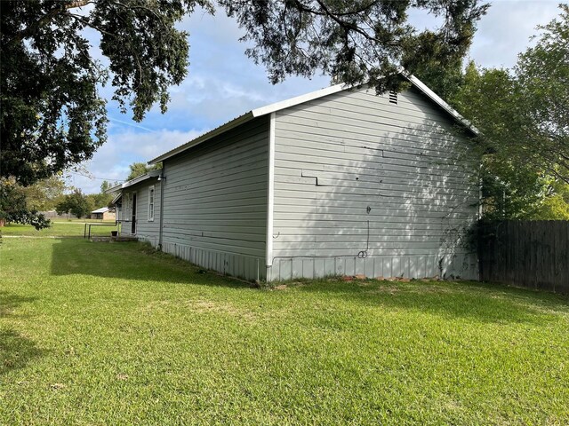 view of side of property with a lawn