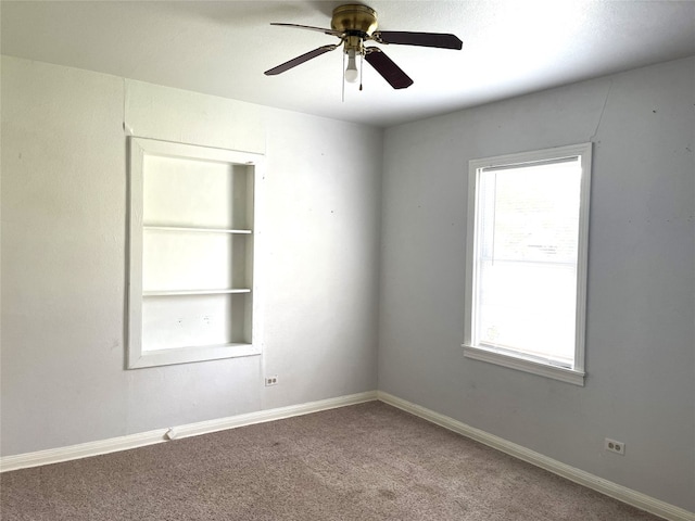 carpeted spare room with ceiling fan and a healthy amount of sunlight