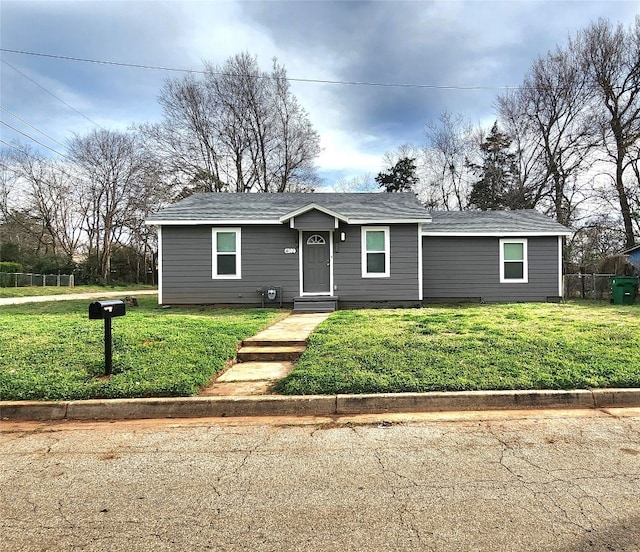 ranch-style home featuring a front yard