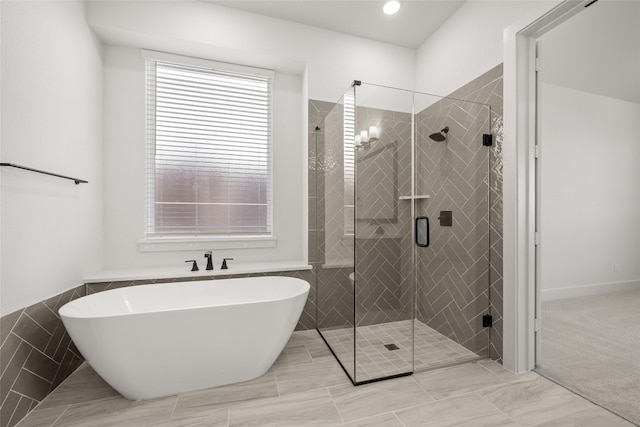 bathroom with a notable chandelier, tile flooring, and separate shower and tub