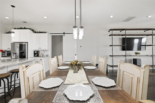 dining room featuring a barn door