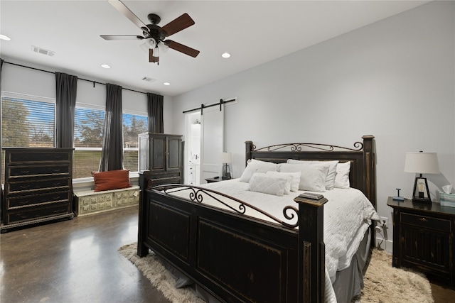 bedroom featuring a barn door and ceiling fan