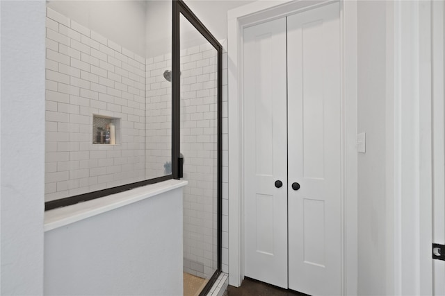 bathroom with a shower with door