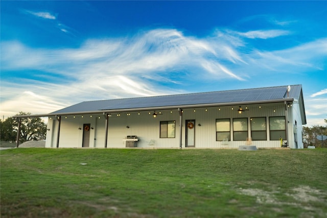 back of property featuring a lawn