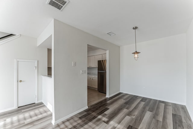 empty room with hardwood / wood-style flooring