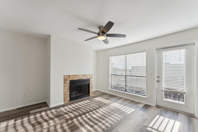 unfurnished living room with hardwood / wood-style flooring and ceiling fan