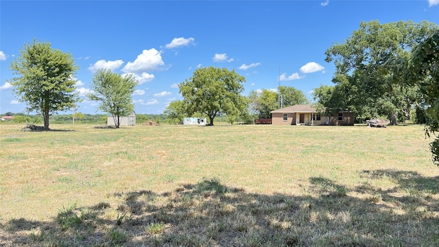 view of yard featuring a storage unit and a rural view