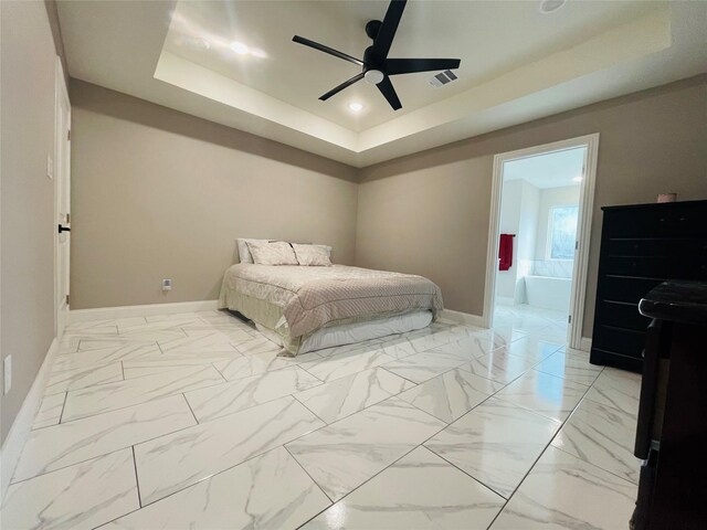 tiled bedroom featuring ensuite bath, ceiling fan, and a raised ceiling