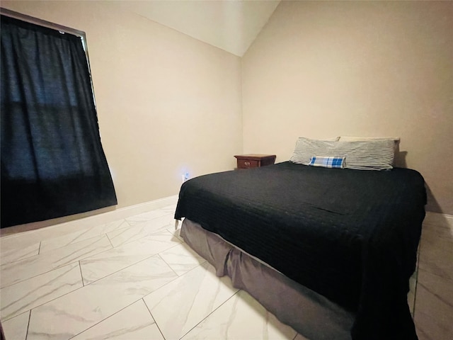 tiled bedroom featuring lofted ceiling