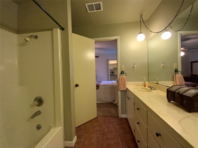 bathroom with shower / bathing tub combination, vanity, and tile patterned floors