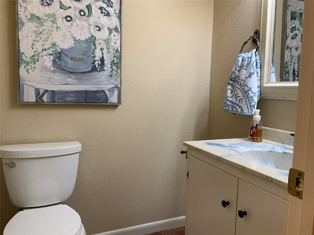 bathroom featuring toilet and vanity