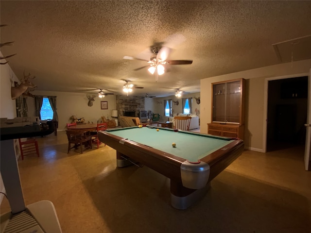 playroom featuring a wealth of natural light, pool table, and a textured ceiling