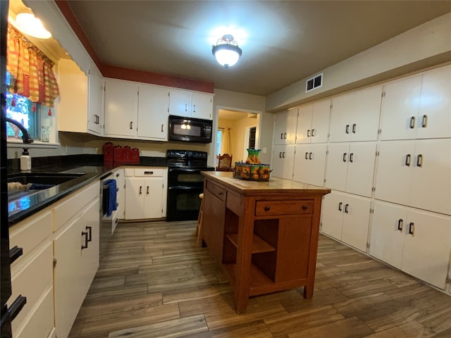 kitchen featuring white cabinetry, sink, black appliances, and dark hardwood / wood-style floors