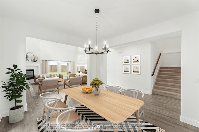 dining room with dark hardwood / wood-style floors and an inviting chandelier