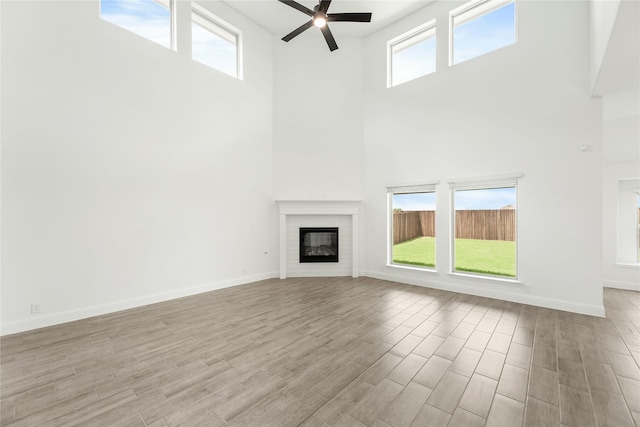 unfurnished living room featuring a wealth of natural light and light wood-type flooring