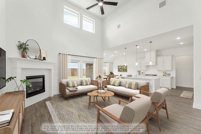 living room with ceiling fan, a healthy amount of sunlight, and dark hardwood / wood-style flooring