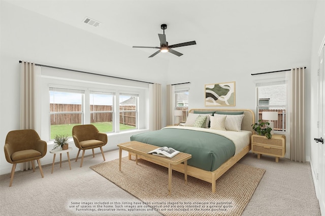 carpeted bedroom featuring ceiling fan and a towering ceiling