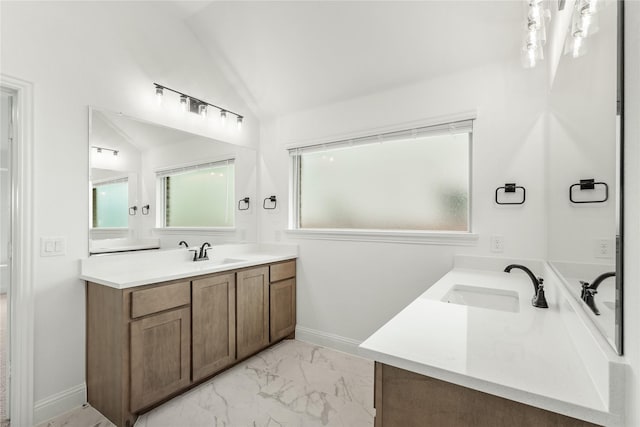 bathroom featuring vanity and lofted ceiling