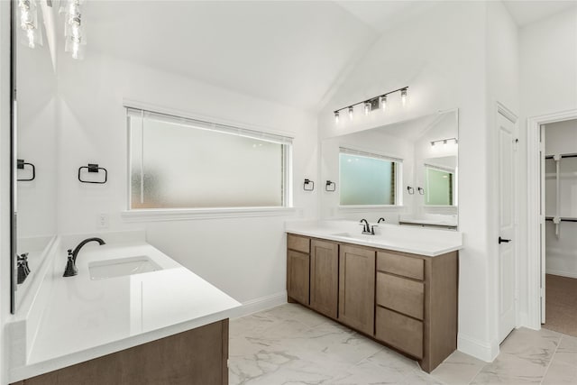 bathroom featuring vaulted ceiling and vanity